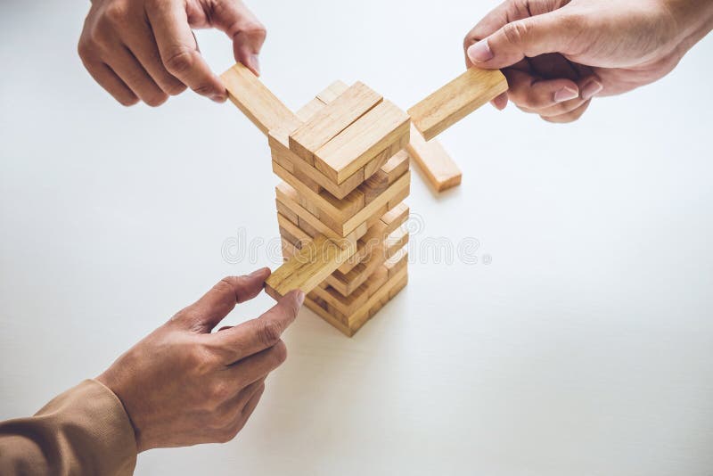 Alternative risk plan and strategy in business, Young intelligent business team playing the wood game, hands of executive royalty free stock image Alternative risk plan and strategy in business, Young intelligent business team playing the wood game, hands of executive royalty free stock image