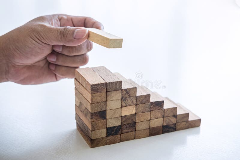 Alternative Risk and Strategy in business to make growth, Image of Business man`s hand placing making a wooden block stacking