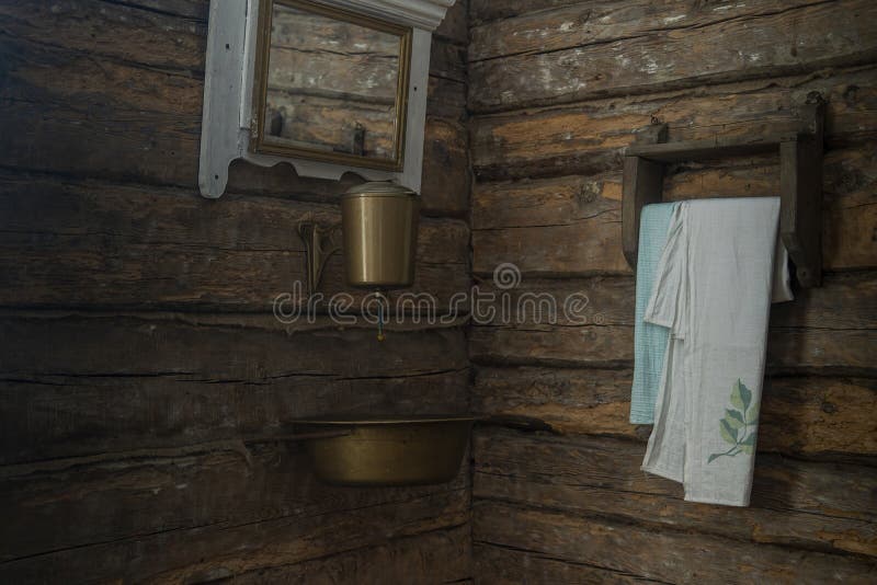 old copper washbasin in an old wooden house. old copper washbasin in an old wooden house.