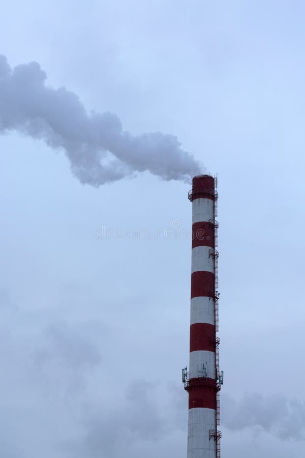Alto CHP del tubo en el fondo del cielo azul, niebla, niebla con humo foto de archivo Alto CHP del tubo en el fondo del cielo azul, niebla, niebla con humo foto de archivo