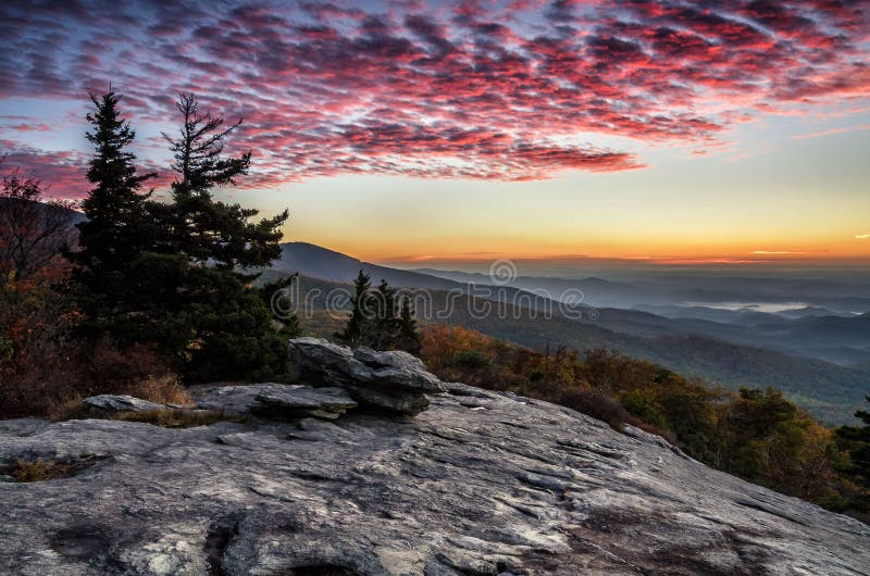 Predawn light from Beacon Heights overlook along the Blue Ridge Parkway in North Carolina. Cirrocumulus clouds are lit by the rising sun. Predawn light from Beacon Heights overlook along the Blue Ridge Parkway in North Carolina. Cirrocumulus clouds are lit by the rising sun.