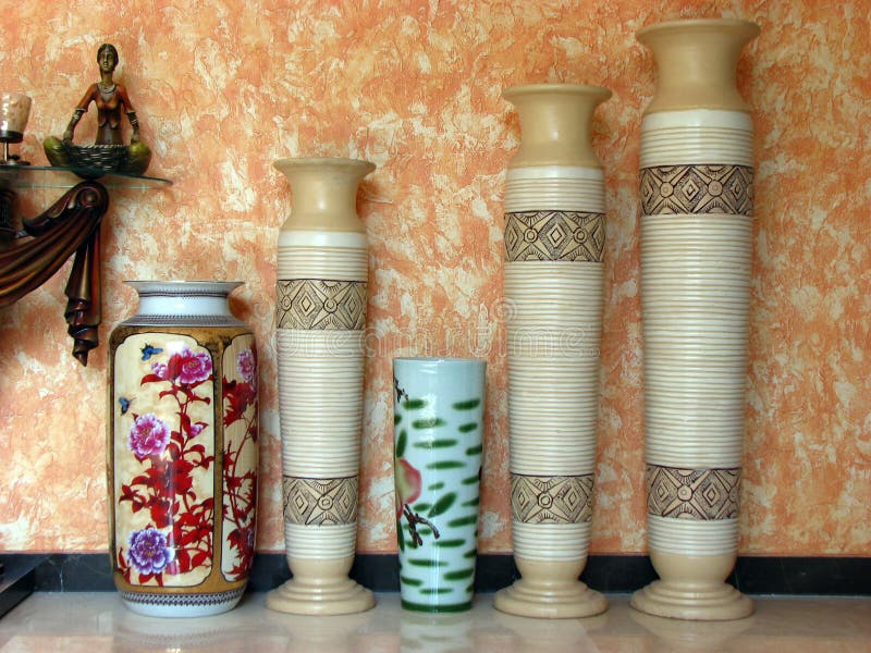 Artistic antique pots of different heights against a textured wall in a royal house. Artistic antique pots of different heights against a textured wall in a royal house