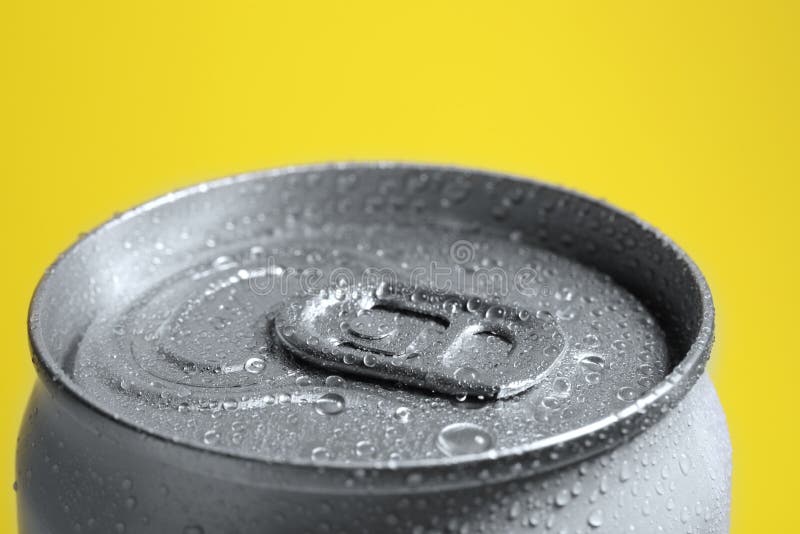 Aluminum Can of Covered with Water Drops on Yellow Background, Closeup