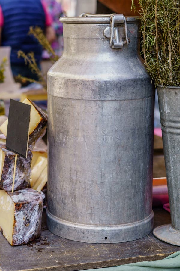 Aluminum Milk Container and Cheese Made from Its Contents Stock Image