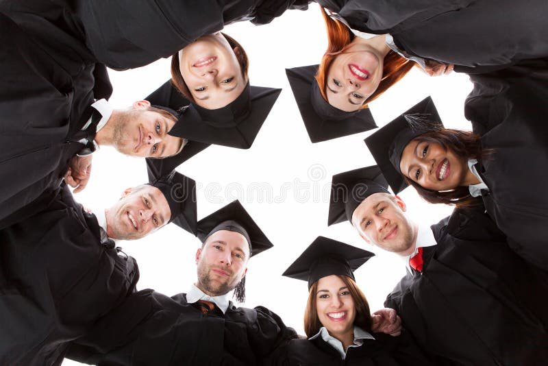 Graduate students standing in circle leaning towards camera. Isolated on white. Graduate students standing in circle leaning towards camera. Isolated on white