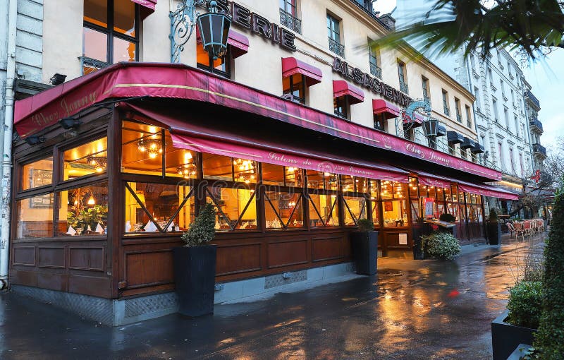 Paris, France-March 10, 2019 : The Alsatian brasserie Chez Jenny at rainy morning . It is traditional French brasserie located near Republic square in Paris, France. Paris, France-March 10, 2019 : The Alsatian brasserie Chez Jenny at rainy morning . It is traditional French brasserie located near Republic square in Paris, France.