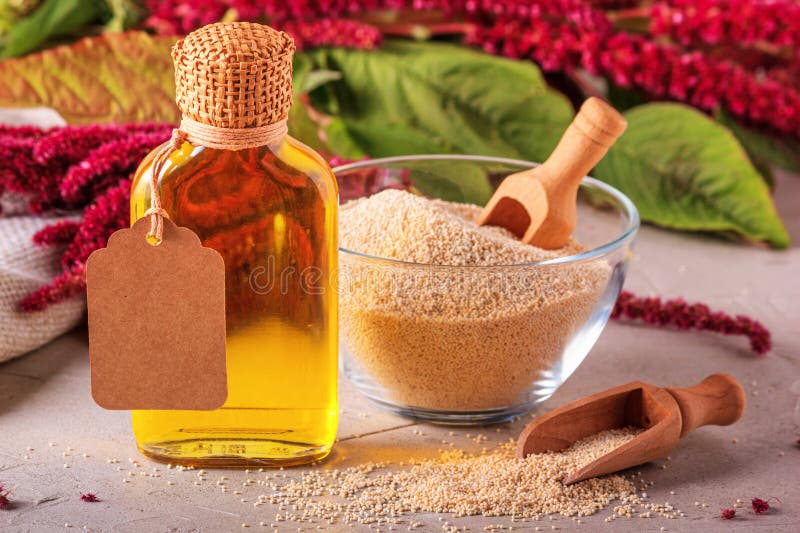 Amaranth Oil in a Bottle and Amaranth Grits in a Glass Bowl Against the