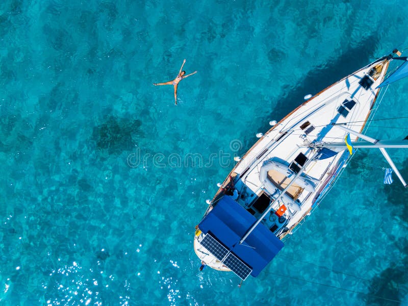 Aerial view to Yacht in deep blue sea. Drone photography