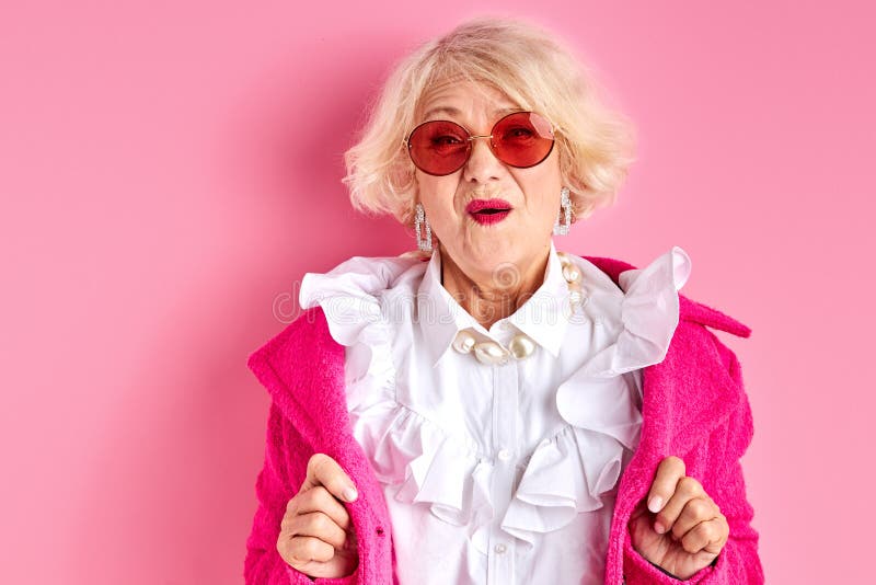 Amazed elderly female in stylish clothes posing royalty free stock images