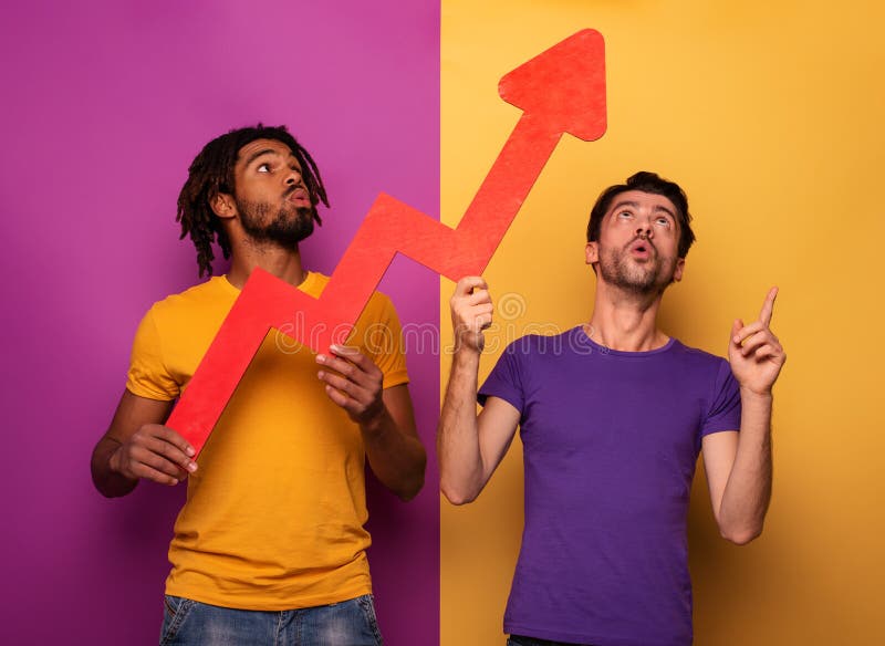 Amazed friends with funny face expression and red arrow statistic. Concept of growth, success, earn. stock image Amazed friends with funny face expression and red arrow statistic. Concept of growth, success, earn. stock image