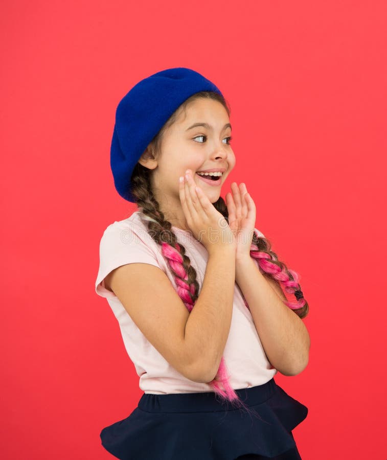Amazed girl. Kid little cute fashion girl posing with long braids and hat red background. Child small girl happy smiling royalty free stock photo Amazed girl. Kid little cute fashion girl posing with long braids and hat red background. Child small girl happy smiling royalty free stock photo