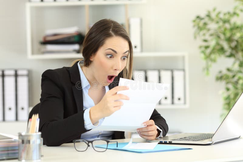 Amazed office worker reading a letter royalty free stock photography Amazed office worker reading a letter royalty free stock photography