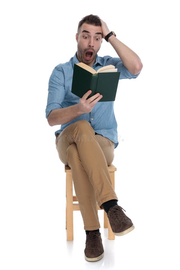Amazed smart casual man reading a book and shouting royalty free stock images
