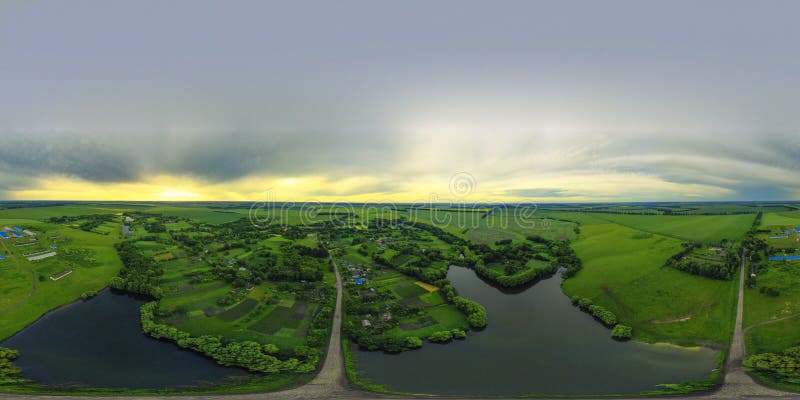 360-degree aerial view from a drone of a large river and green meadows. Beautiful bright landscape photography with