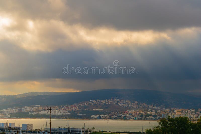 Amazing beautiful panoramic view of marina, on which small storm is approaching. Sun rays, beams passing through layers stock photography