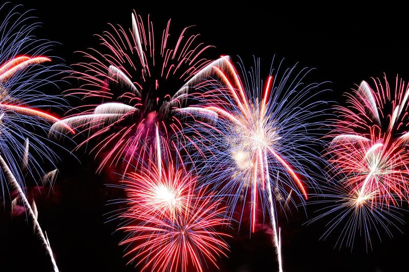 Amazing blue, white and red fireworks on dark background