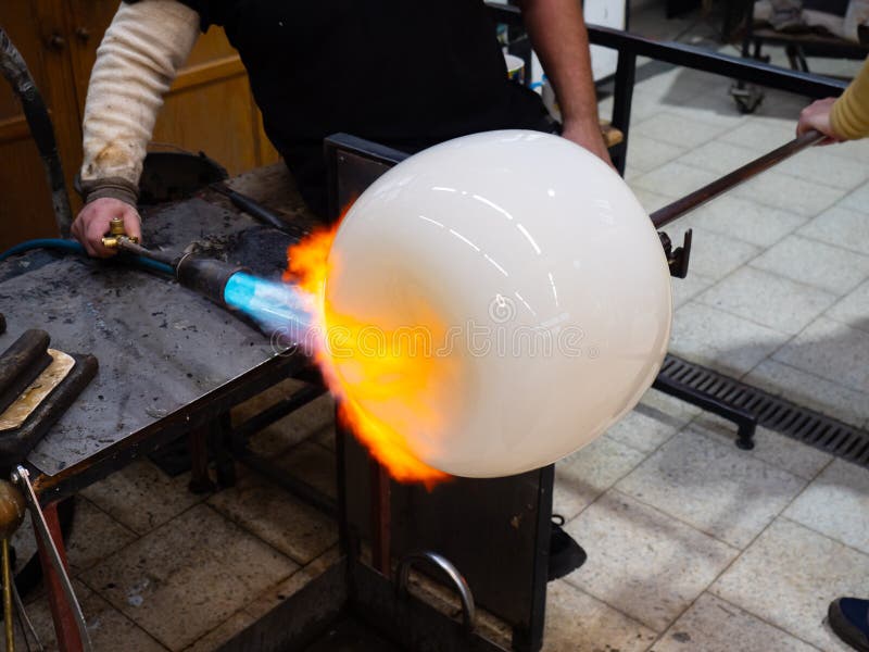 Amazing creation of a work of art from molten glass. The blue flame royalty free stock photos