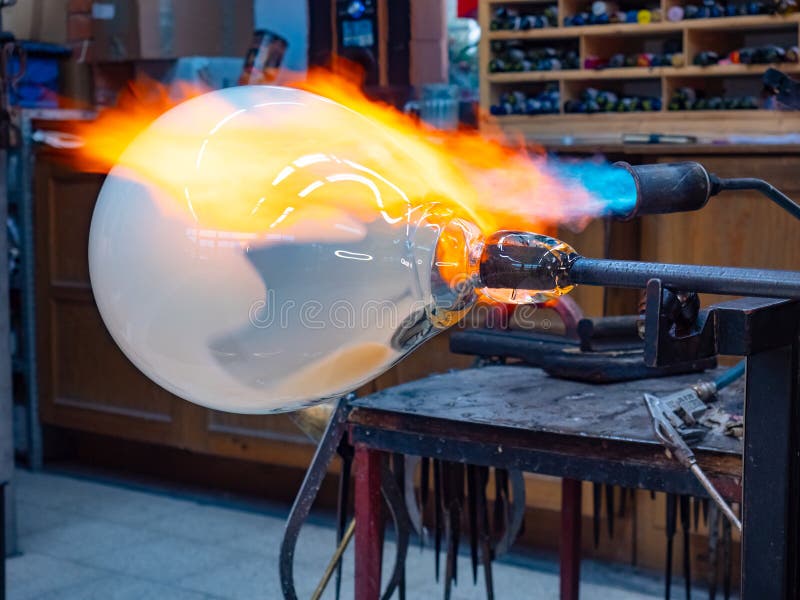 Amazing creation of a work of art from molten glass. The blue flame stock photos