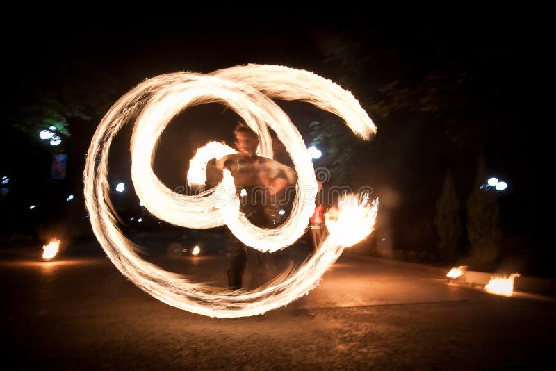Amazing Fire Show Dance. Fire Dancer Playing with Flame Stock Photo