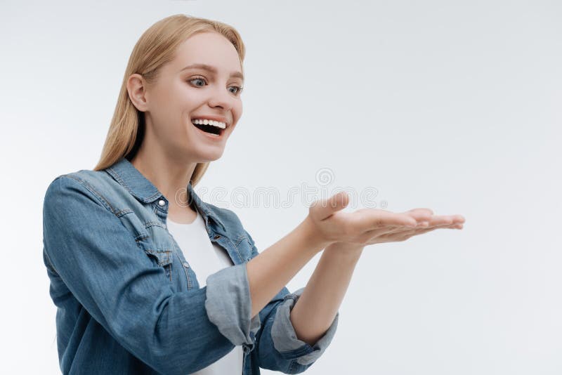 Amazing girl feeling happiness while presenting something royalty free stock image Amazing girl feeling happiness while presenting something royalty free stock image