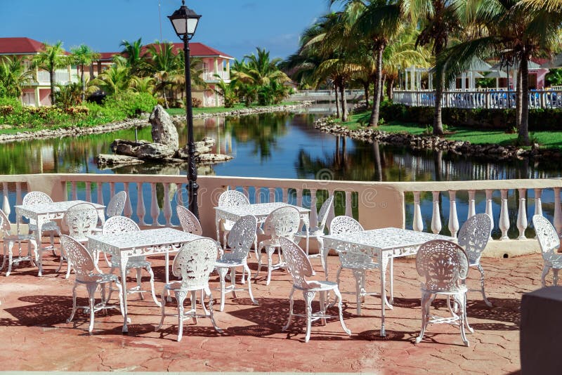 Amazing , gorgeous inviting view of Memories resort landscape, outdoor cafe, patio with metal vintage retro classic chairs stock photo Amazing , gorgeous inviting view of Memories resort landscape, outdoor cafe, patio with metal vintage retro classic chairs stock photo