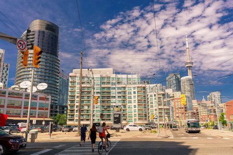 Amazing, inviting view of Toronto down town area with modern stylish buildings, cars bus and people walking through the streets