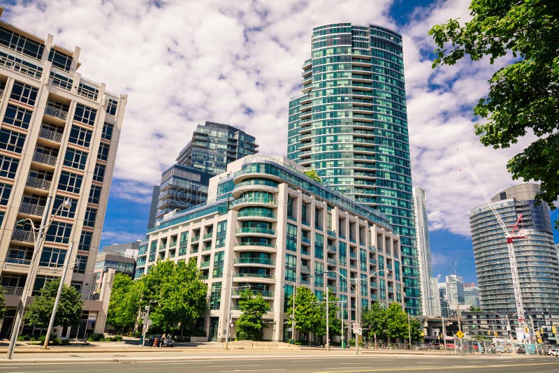 Amazing, inviting view of Toronto down town area with modern stylish residential condo buildings, cars and people walking in backg