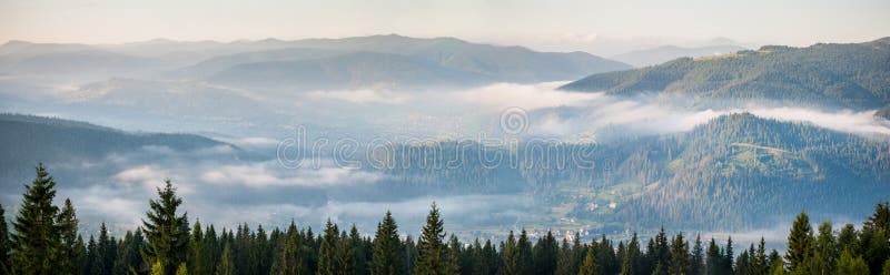 Amazing panorama of foggy mountain range