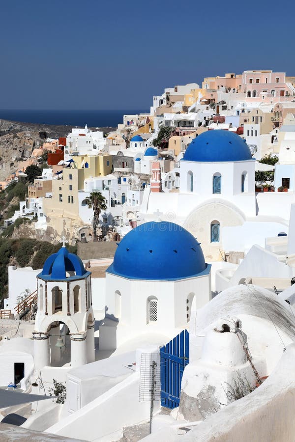 Amazing panorama view with white houses and blue domes in Oia village on Santorini island, Greece stock image Amazing panorama view with white houses and blue domes in Oia village on Santorini island, Greece stock image