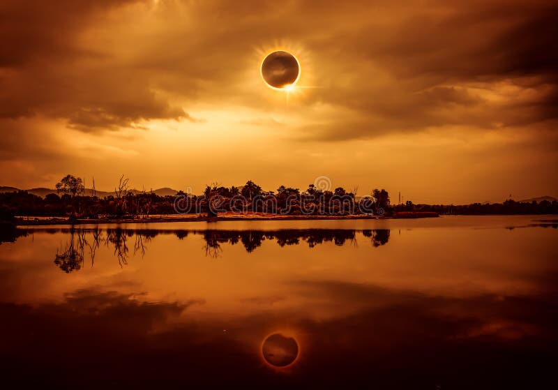 Amazing scientific natural phenomenon. The Moon covering the Sun. Total solar eclipse with diamond ring effect glowing on sky