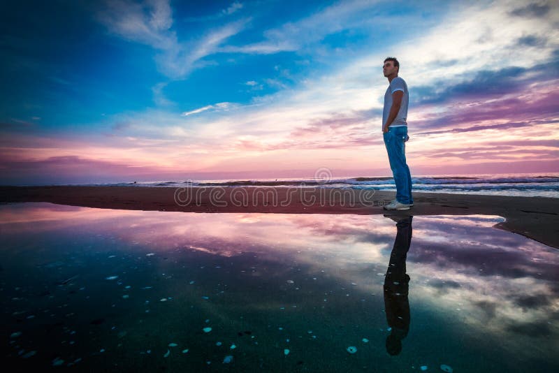 Amazing sea sunset with reflection. Solitary man