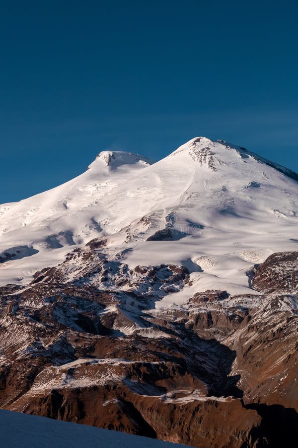 Amazing snowy mountain landscape of the Caucasus, peaks of mount Elbrus on a clear blue sky day