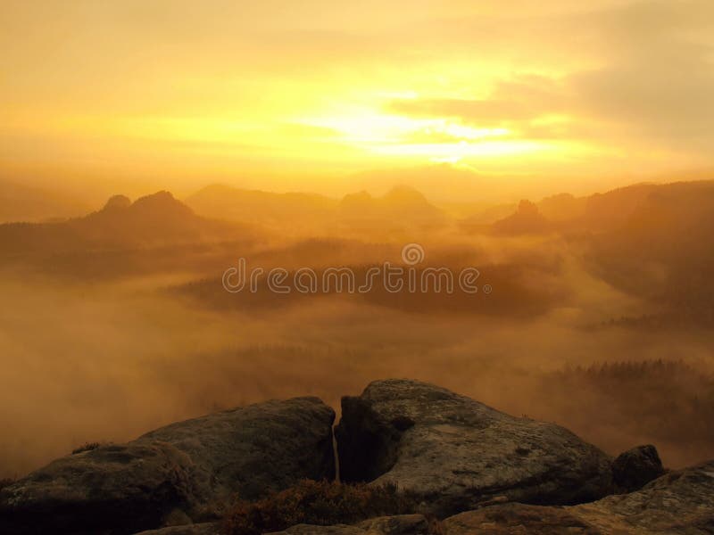 Amazing sunrise in a beautiful mountain of Czech-Saxony Switzerland park. Rocky hills peaks increased from foggy background. stock photo Amazing sunrise in a beautiful mountain of Czech-Saxony Switzerland park. Rocky hills peaks increased from foggy background. stock photo