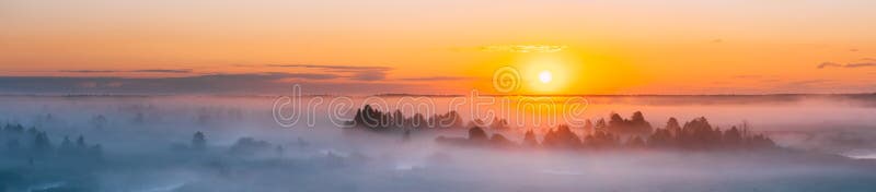 Amazing Sunrise Over Misty Landscape. Scenic View Of Foggy Morning