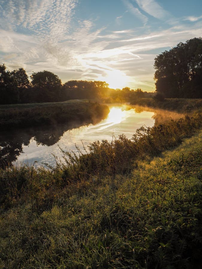 Amazing sunrise over the river Dyle in Mechelen, Belgium. During a misty early morning in September royalty free stock images