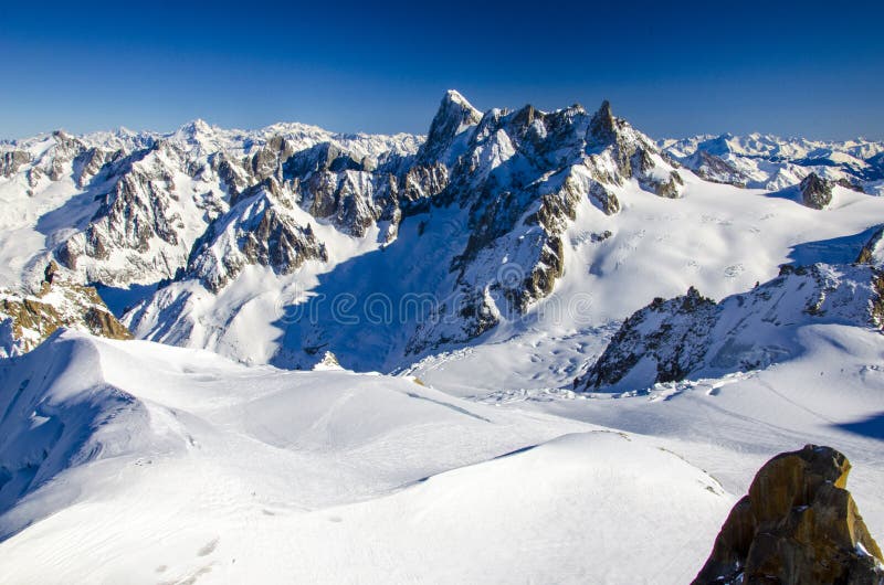 Amazing view of french Alps with the summits covered with snow. Winter holiday in Chamonix-Mont-Blanc during sunny day. Best place for winter holiday, skiing and snowboarding.
