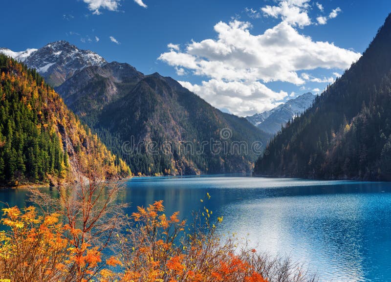 The Long Lake Among Fall Wooded Mountains In Fog Jiuzhaigou Stock