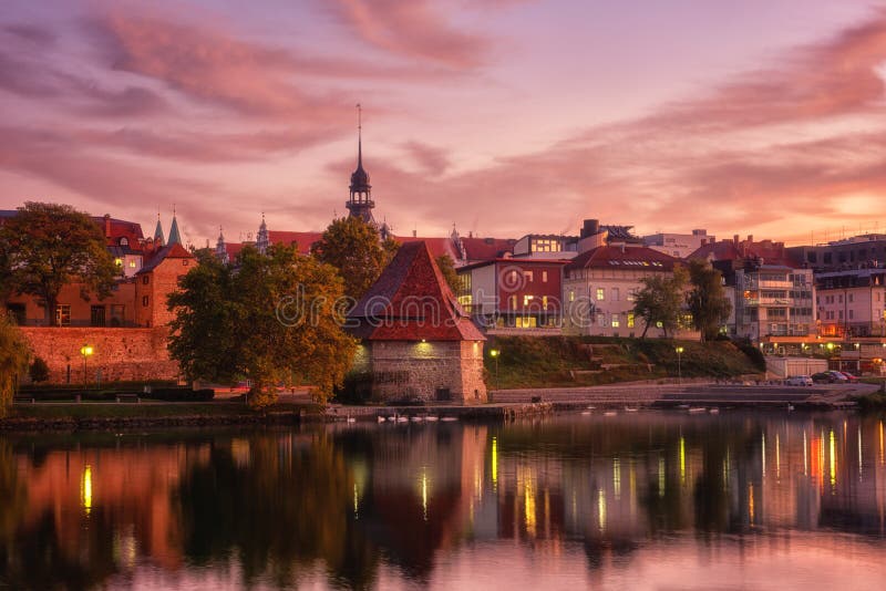 Amazing view of Maribor Old city, medieval water tower on the Drava river before sunrise, Slovenia. Scenic cityscape