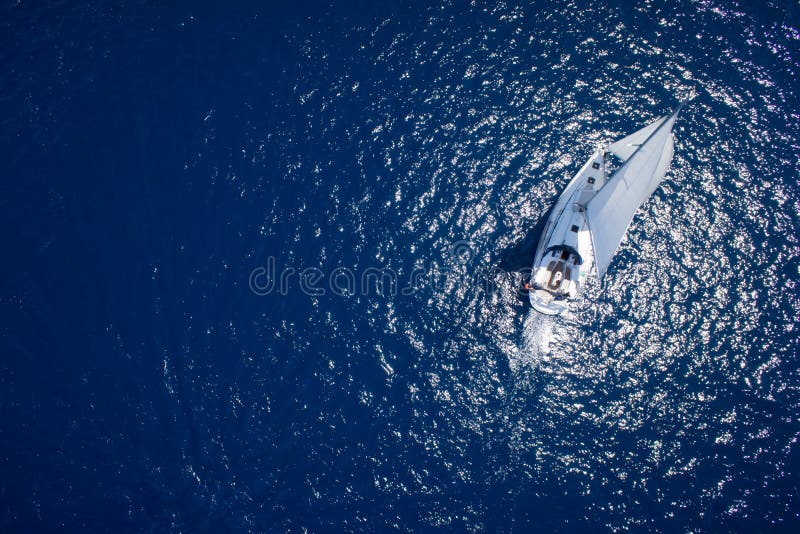 Amazing view to Yacht sailing in open sea at windy day. Drone view - birds eye angle