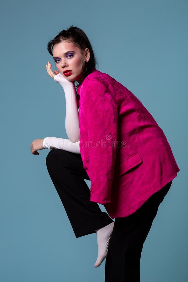 Amazing young brunett woman in trendy pink jacket standing on one leg stock images Amazing young brunett woman in trendy pink jacket standing on one leg stock images