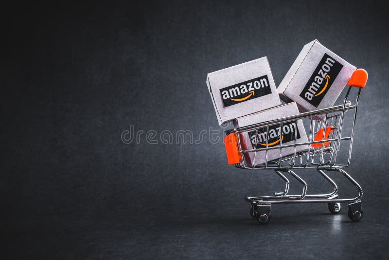 Amazon shipping packages boxes and shopping cart on black background