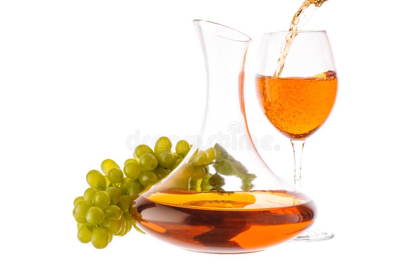 Amber wine. Wine in a glass and decanter near grapes. Wine is poured into a glass. Traditional Georgian wine according to ancient technology. Isolated on white royalty free stock photo Amber wine. Wine in a glass and decanter near grapes. Wine is poured into a glass. Traditional Georgian wine according to ancient technology. Isolated on white royalty free stock photo