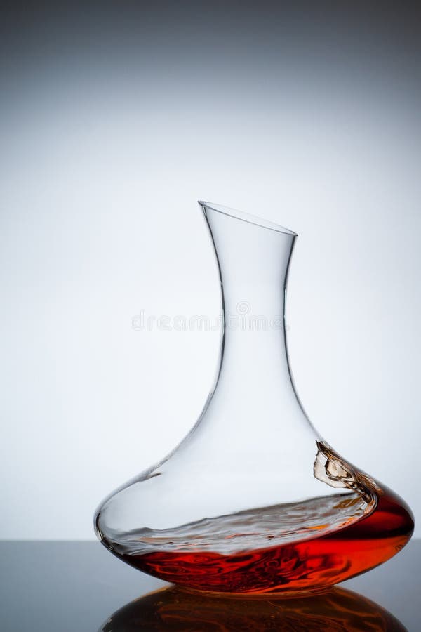Amber wine. A splash of wine in decanter. Traditional wine according to the ancient Georgian technology. Concept. Copy space. Close up and vertical orientation stock photography Amber wine. A splash of wine in decanter. Traditional wine according to the ancient Georgian technology. Concept. Copy space. Close up and vertical orientation stock photography