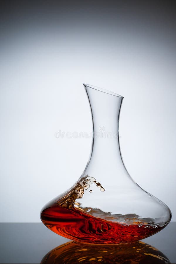 Amber wine. A splash of wine in decanter. Traditional wine according to the ancient Georgian technology. Concept. Copy space. Close up and vertical orientation royalty free stock photos Amber wine. A splash of wine in decanter. Traditional wine according to the ancient Georgian technology. Concept. Copy space. Close up and vertical orientation royalty free stock photos