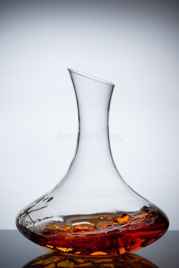Amber wine. A splash of wine in decanter. Traditional wine according to the ancient Georgian technology. Concept. Copy space. Close up and vertical orientation royalty free stock image Amber wine. A splash of wine in decanter. Traditional wine according to the ancient Georgian technology. Concept. Copy space. Close up and vertical orientation royalty free stock image