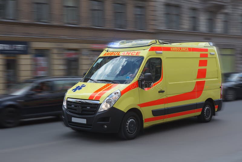 Ambulance moves on a city street. Motion blur