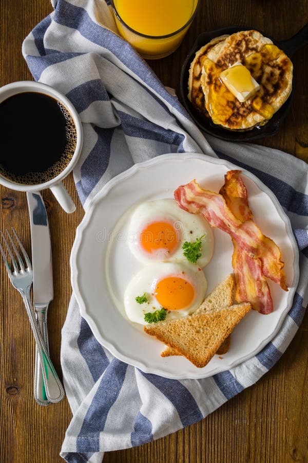 American Breakfast With Sunny Side Up Eggs Bacon Toast Pancakes