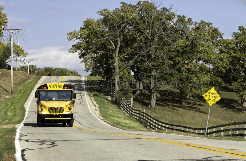 American country asphalt road with school bus sign