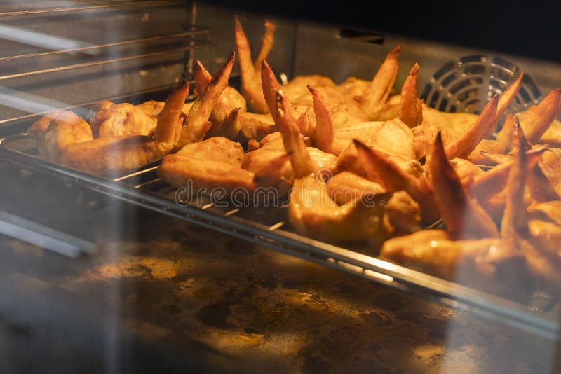 American Cuisine. Fried Chicken Wings, in the Process of Cooking in the