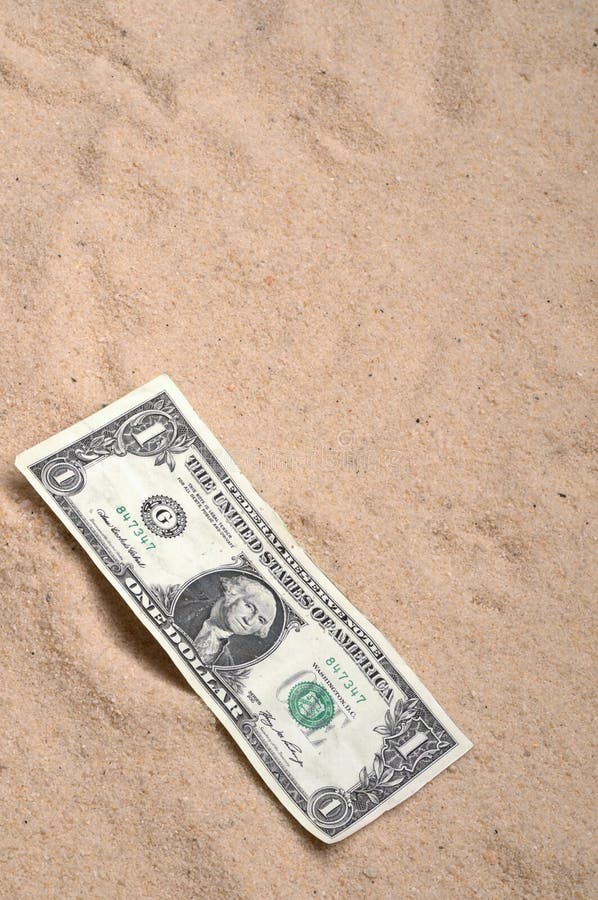 An American dollar bill on the sand